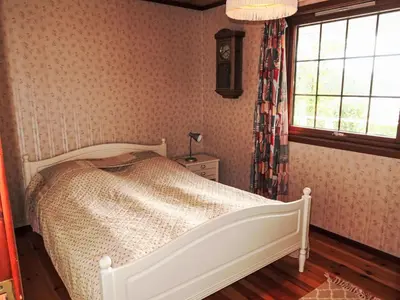 a bedroom with a bed and a window at Holiday Home Askelund by Interhome in Uggdal