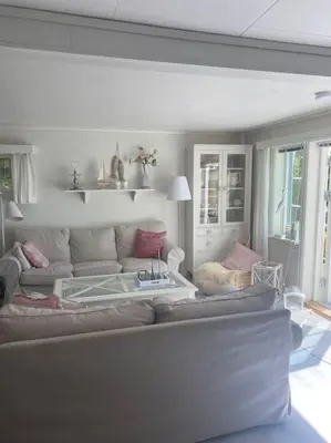 a living room with a couch and a table at Drømmested for idylliske dager in Skjoldastraumen