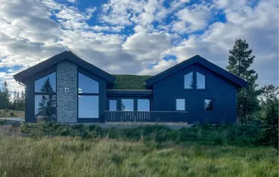 a blue house with a green roof at 5 Bedroom Stunning Home In Løten in Løten