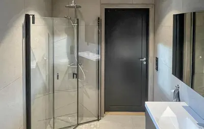 a glass shower door in a bathroom with a sink at 5 Bedroom Stunning Home In Løten in Løten