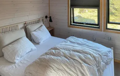 a bed with white sheets and pillows in a room at Nice Home In Lysøysundet With Wifi in Lysøysund