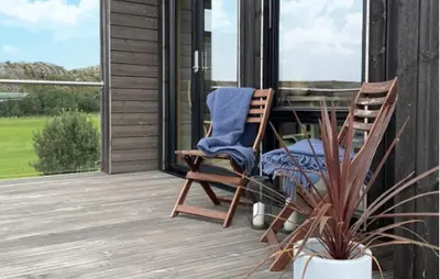 a rocking chair on the porch of a house at Nice Home In Lysøysundet With Wifi in Lysøysund
