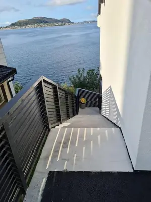 a stairway with a view of a body of water at Fjord view in centre with parking in Ålesund