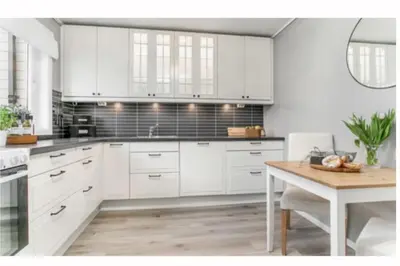 a kitchen with white cabinets and a wooden table at Entire house less than 2 km from Granåsen, WC 2025 in Trondheim