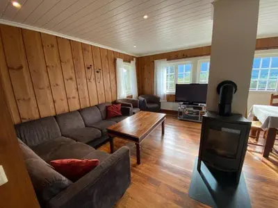 a living room with a couch and a wood stove at Ruud Tun in Hafjell