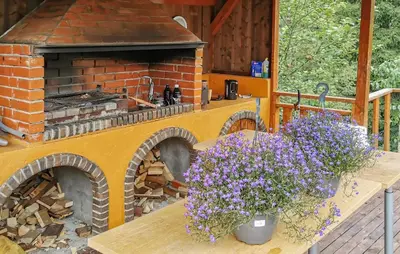 a table with flowers on it next to a brick oven at Gorgeous Home In Førde in Førde
