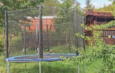 a trampoline in the grass with a person on it at Gorgeous Home In Førde in Førde