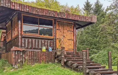 an old wooden cabin with a window and stairs at Gorgeous Home In Førde in Førde
