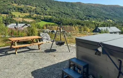 a picnic table and a swing on top of a house at Lovely Home In Uvdal With Sauna in Uvdal