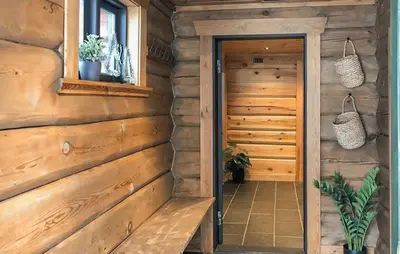 a room with a wooden wall with a wooden door at Lovely Home In Uvdal With Sauna in Uvdal