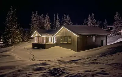 a small house in the snow at night at Gorgeous Home In Svingvoll With Wifi in Svingvoll