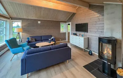 a living room with a couch and a fireplace at Gorgeous Home In Svingvoll With Wifi in Svingvoll