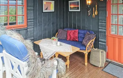 a patio with a couch and a table and chairs at Stunning Home In Rjukan With Sauna in Rjukan