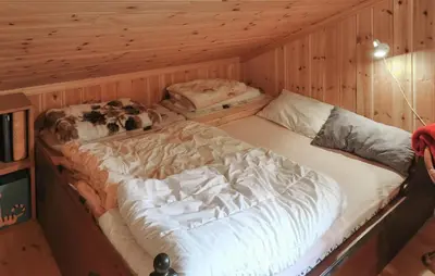 a couple of beds in a wooden room at Stunning Home In Rjukan With Sauna in Rjukan