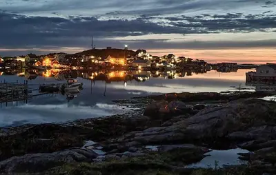 a view of a marina at night with the lights on at 3 Bedroom Amazing Home In Sula in Sula