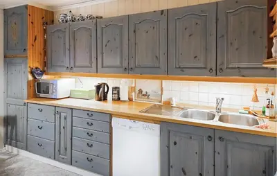 a kitchen with gray cabinets and a sink at 3 Bedroom Amazing Home In Sula in Sula