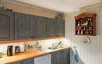 a kitchen with gray cabinets and a sink at 3 Bedroom Amazing Home In Sula in Sula