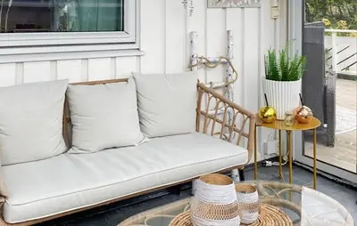 a couch sitting on a porch with a table at Gorgeous Home In Sørbøvågen With Wifi in Saltbu