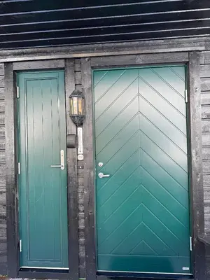 two green doors next to each other on a building at Cozy Apartment - Great View! in Håra