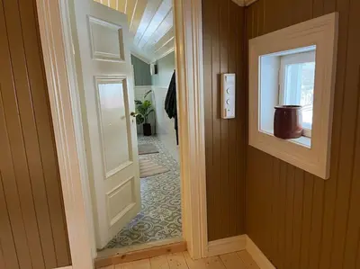 an open door in a room with a hallway at Historisk villa med klassiske detaljer in Snertingdal