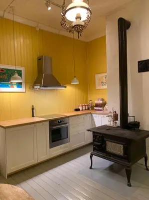 a kitchen with a stove in the middle of it at Historisk villa med klassiske detaljer in Snertingdal