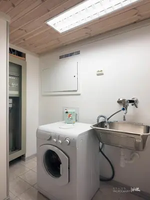 a bathroom with a washing machine and a sink at Modern cabin in Vestlia - EV Type 2 - Sauna - WiFi - Games in Geilo