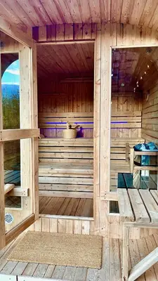 a wooden sauna with a bench in the middle at Modern cabin in Vestlia - EV Type 2 - Sauna - WiFi - Games in Geilo