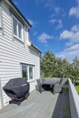 a deck with a grill and a table on a house at Haus Soltun-Was will man mehr! in Runde
