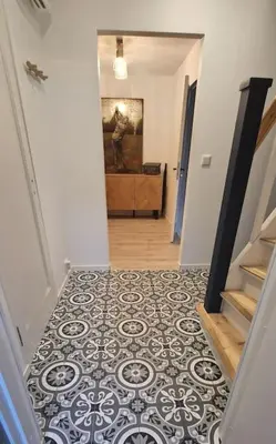 a hallway with a stairway with a black and white floor at Haus Soltun-Was will man mehr! in Runde