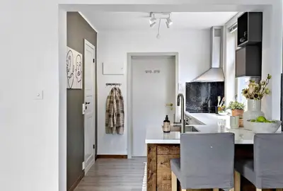 a kitchen with white cabinets and a counter top at Koselig leilighet ved Solsiden in Trondheim