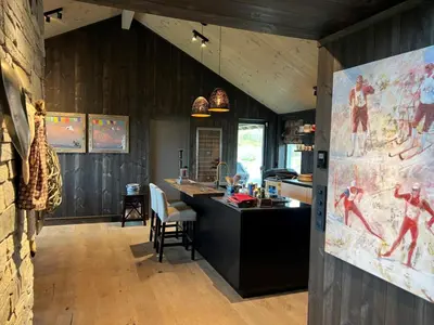 a kitchen with a large painting on the wall at Spacious, exclusive and modern cabin in Geilo in Geilo
