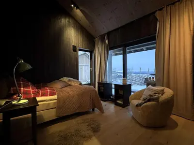 a bedroom with a bed and a large window at Spacious, exclusive and modern cabin in Geilo in Geilo