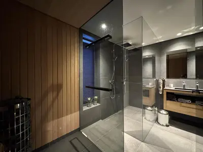 a bathroom with a glass shower and a sink at Spacious, exclusive and modern cabin in Geilo in Geilo