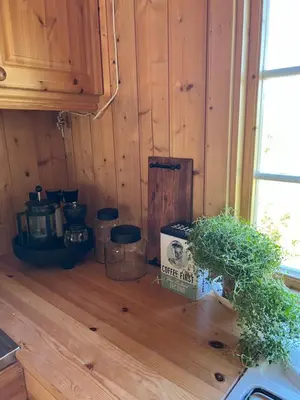 a kitchen with wooden walls and a wooden floor at Øyangen 3 in Rogne