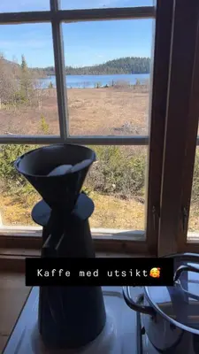 a window with a view of a field at Øyangen 3 in Rogne