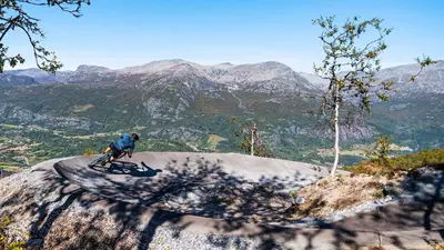 a man riding a bike on top of a mountain at Exclusive Ski In-Out apartment in Hemsedal next to Fyri Resort in Hemsedal