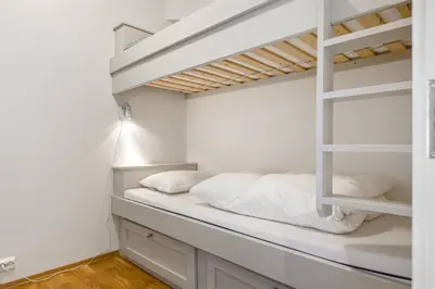 a bedroom with a bunk bed with white pillows at Nydelig utsikt, ski in out, 3 soverom in Aurdal