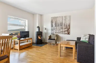 a living room with a couch and a fireplace at Nydelig utsikt, ski in out, 3 soverom in Aurdal