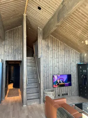a living room with a staircase and a television at Roaldsida Retreat in Stranda
