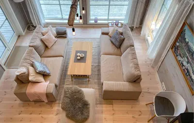a living room with a couch and a table at 4 Bedroom Nice Home In Hildre in Hildre