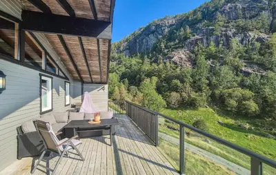 a balcony of a house with a table and chairs at 5 Bedroom Cozy Home In Hebnes in Hebnes