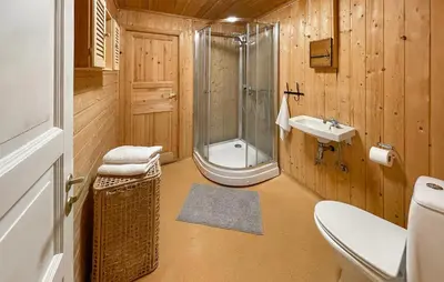 a bathroom with a shower and a toilet and a sink at 5 Bedroom Cozy Home In Hebnes in Hebnes