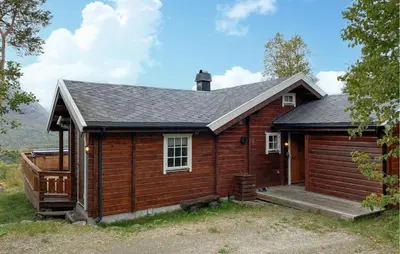a small wooden cabin with a porch at Lovely Home In Bjorli With Wifi in Bjorli