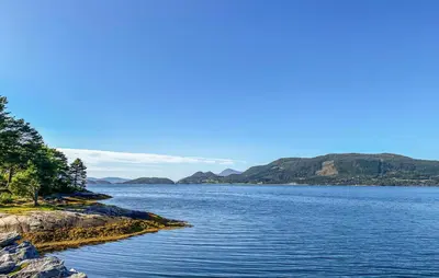 a large body of water with mountains in the background at 3 Bedroom Beautiful Home In Torvikbukt in Torvikbukt