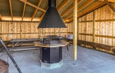 a inside of a wooden barn with a stove at 3 Bedroom Beautiful Home In Torvikbukt in Torvikbukt