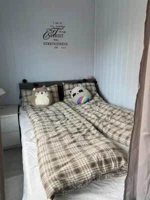 a bed with two hello kitty pillows on it at Koselig rekkehus med tre soverom in Trondheim