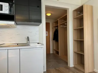 a kitchen with a sink and a kitchen with a closet at Bitihorn hotellfølelse i sentrum in Beitostøl