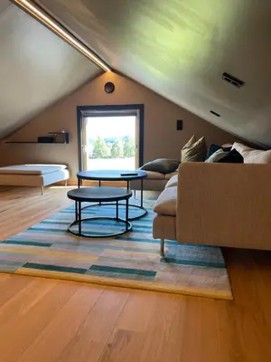 a living room with a couch and a table at Leilighet på to plan nyoppusset sentralt på Tyholt Trondheim in Trondheim