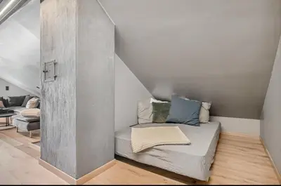 a small room with a bed in the corner at Leilighet på to plan nyoppusset sentralt på Tyholt Trondheim in Trondheim