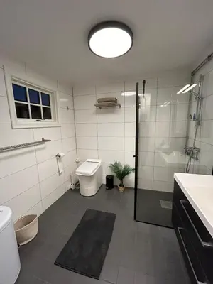 a bathroom with a shower and a toilet and a sink at Sjusjøstua by Norgesbooking - cabin close to cross country trails in Ringsaker